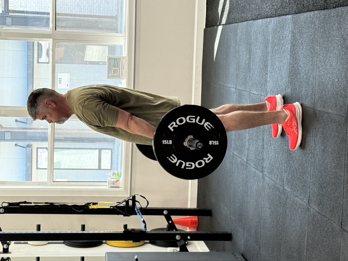 Athletic plank training with barbell at Elev8 performance gym